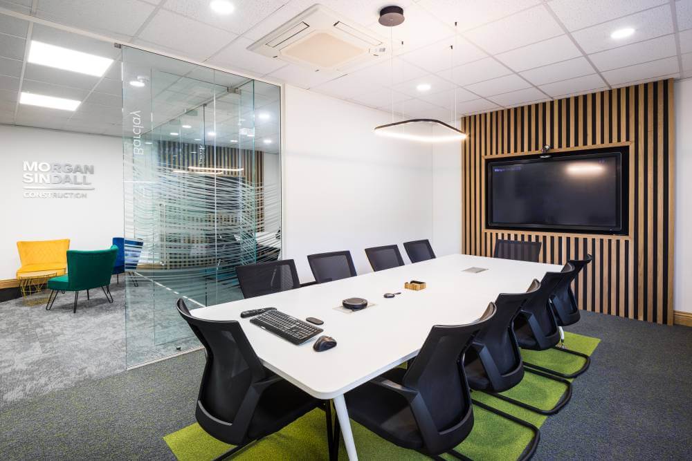 MORGAN SINDALL meeting room with wooden wall and TV