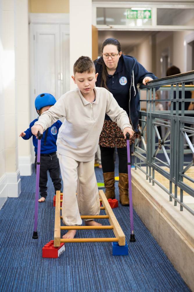 Child stepping through a ladder on the floor