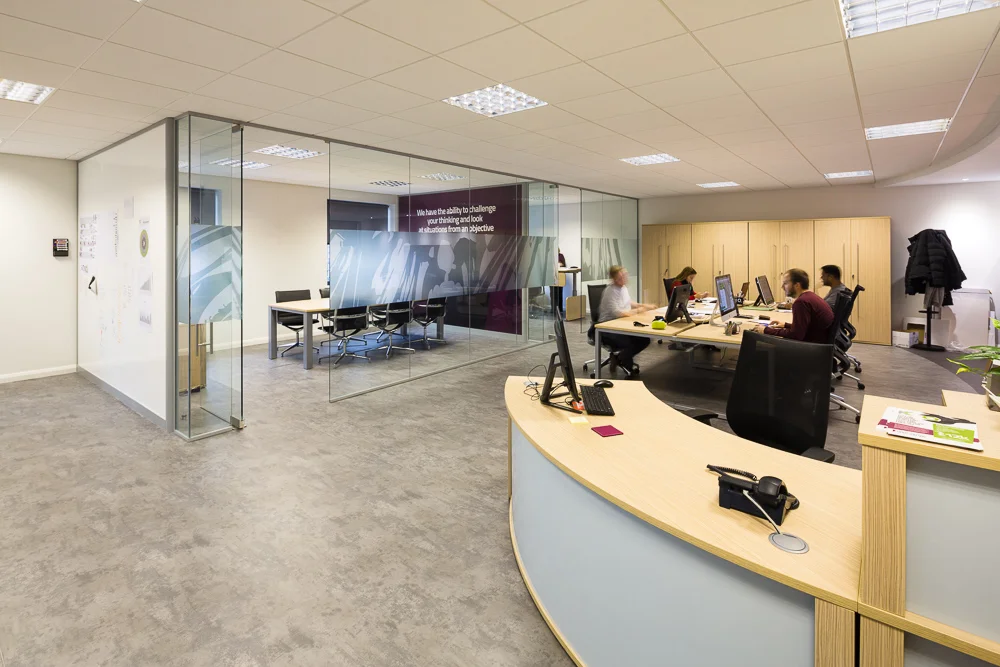 A very modern office space with a glass partition room