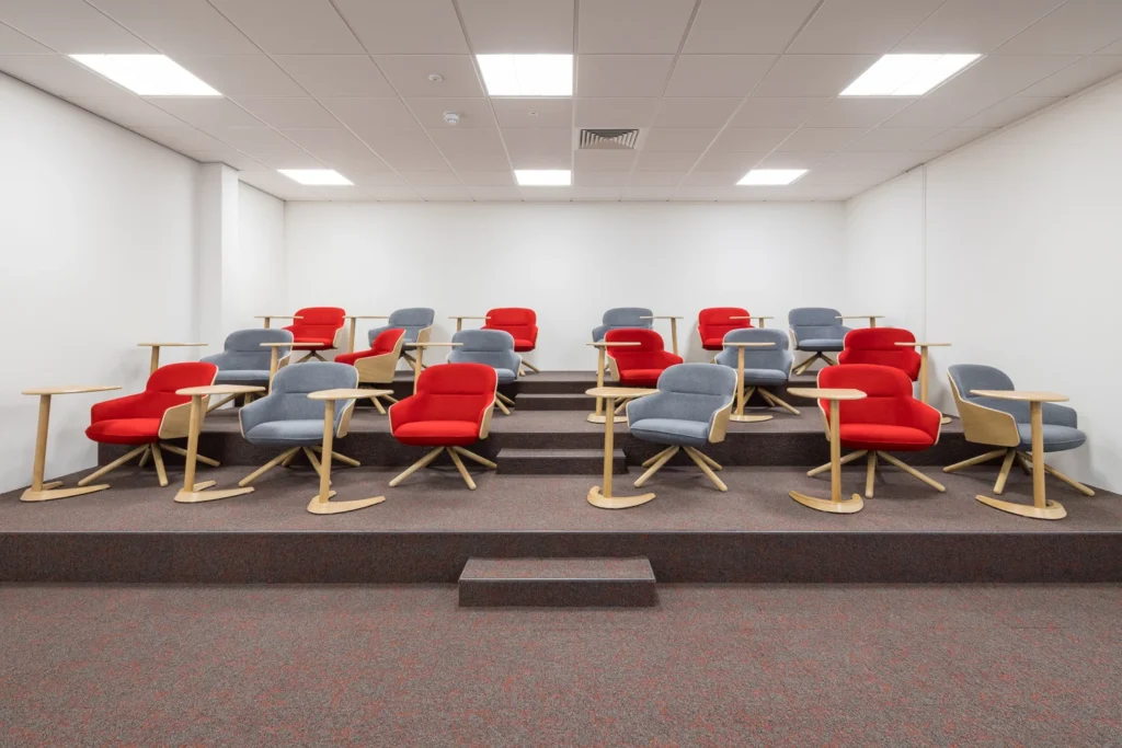 A presentation room with plenty of seating and tables