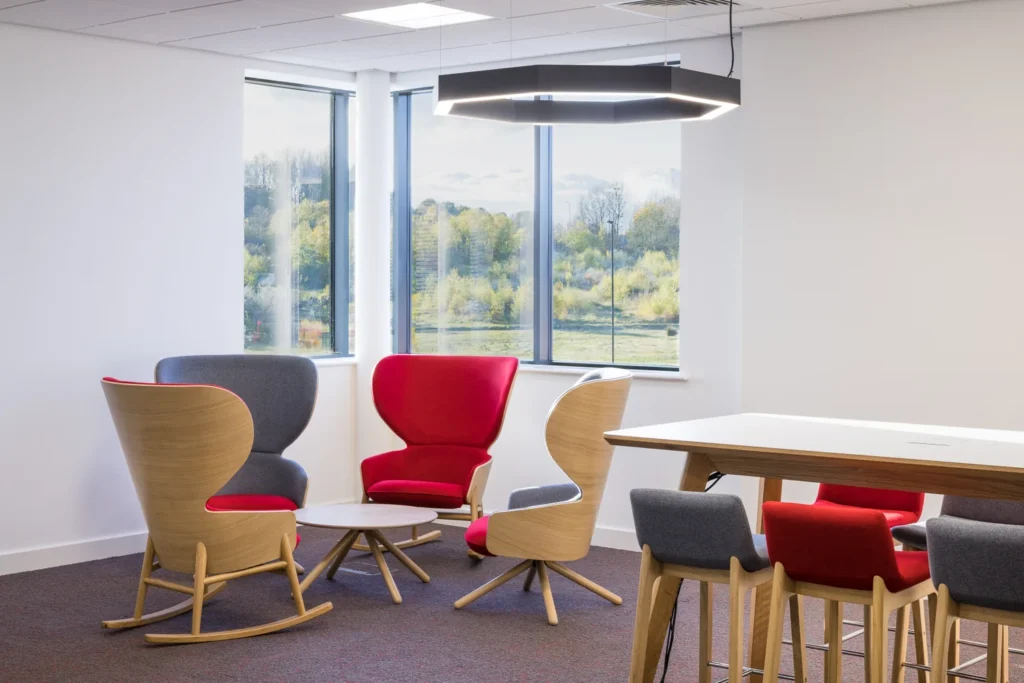 A very modern office space with abstract chairs and low and high tables