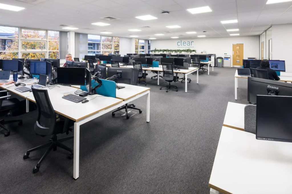 "Modern office fit out with open-plan workstation layout, contemporary desk systems, integrated lighting, collaborative workspace design, and spacious commercial office interior.
